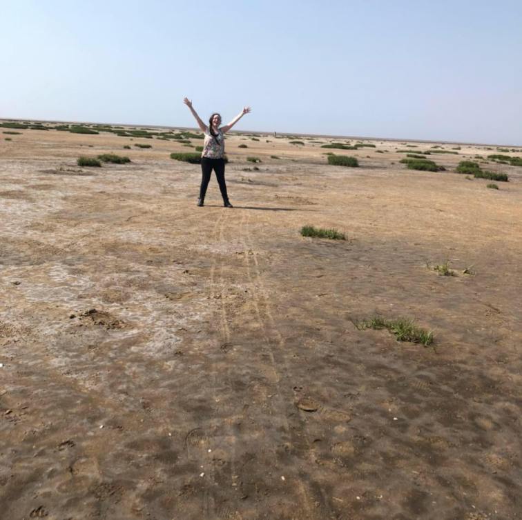 Queering the beach by doing silly poses.
